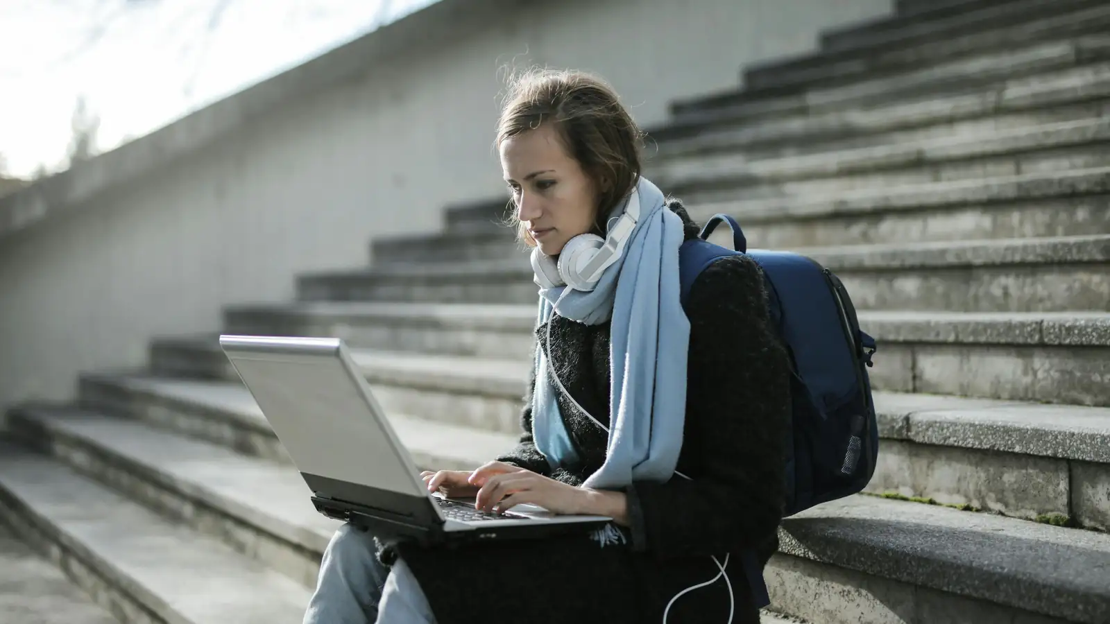 Student learning English on a smartphone in the city